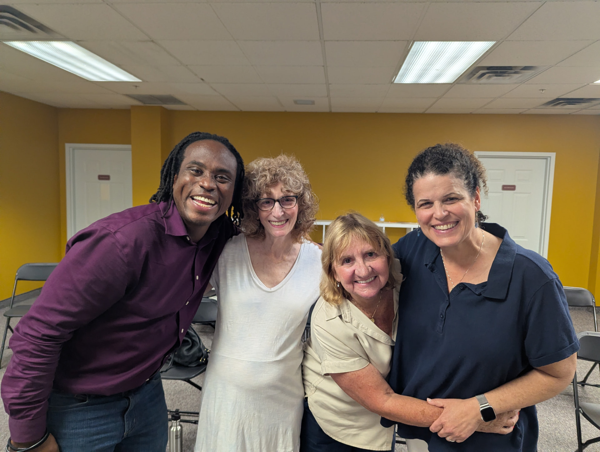 Four smiling MF Improv community members after a class together